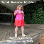 Tessa with microphone on the stage. Text: Tahaki Reserve, Mt Eden. Outdoor comedy Winter series 2025