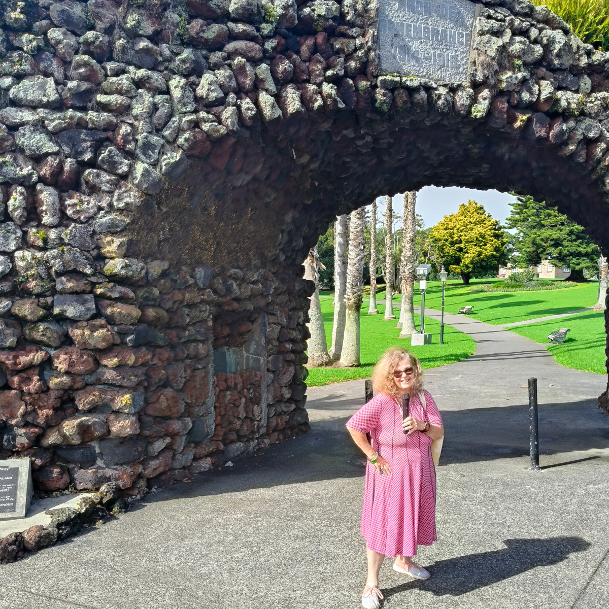 Tessa stands before the memorial arch at the entrance to Jellicoe Park, Onehunga