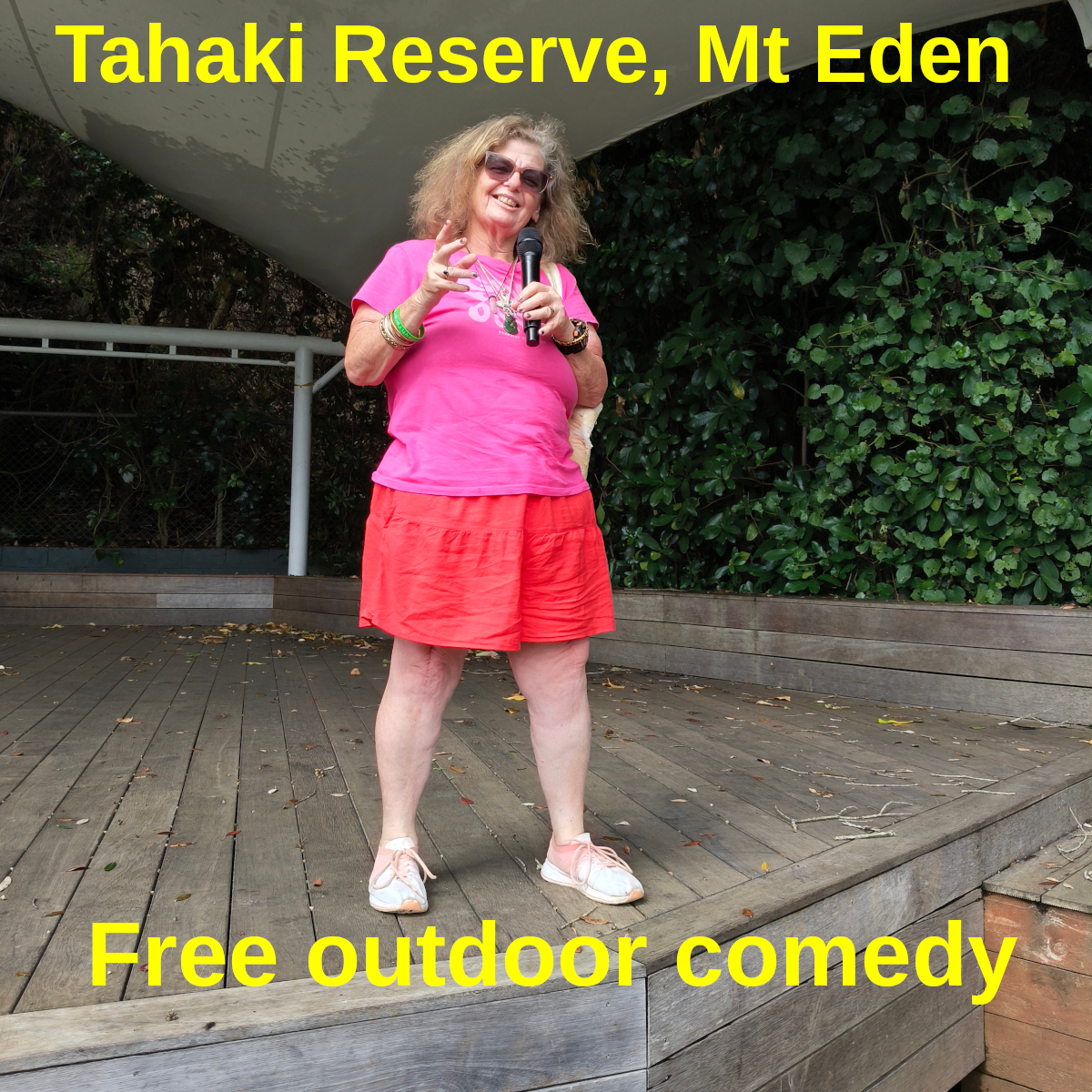 Tessa with microphone on the wooden stage at Tahiki Reserve, Mt Eden